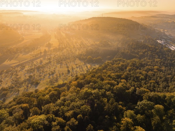 Wide view over misty forests and hills at sunrise, Hermann Hesse railway, Ostelsheim, Black Forest, Germany