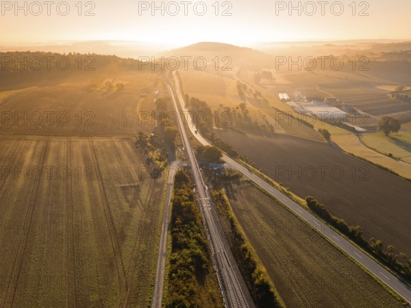 View of a railway network, fields and roads at dawn, Hermann Hesse Railway, Ostelsheim, Black Forest, Germany