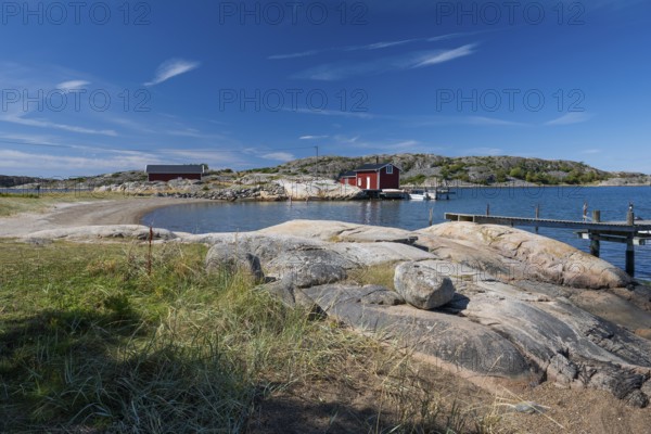 Falun red or Swedish red boathouse in a small bay, Resö island, Bohuslän, Skagerrak, Sotenäs, Västra Götalands län, Sweden