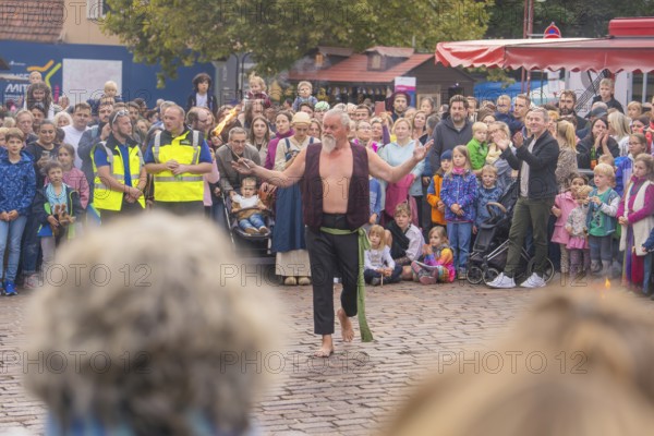 Numerous spectators watch a fire artist at a public event, Feuernacht, Sindelfingen, Germany