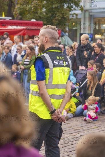 A security guard monitors an event with many spectators, Feuernacht, Sindelfingen, Germany