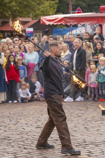 A juggling artist performs fire tricks in front of an interested audience, Feuernacht, Sindelfingen, Germany