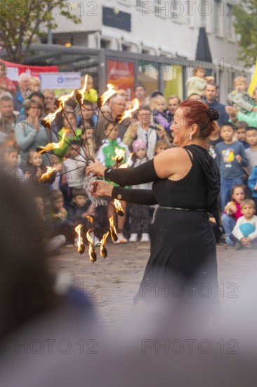 A dancer holds torches in her hand and fascinates the audience with her performance, Feuernacht, Sindelfingen, Germany