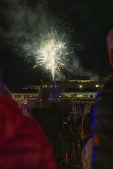 Fireworks light up the night sky while spectators watch in the dark, Fire Night, Sindelfingen, Germany