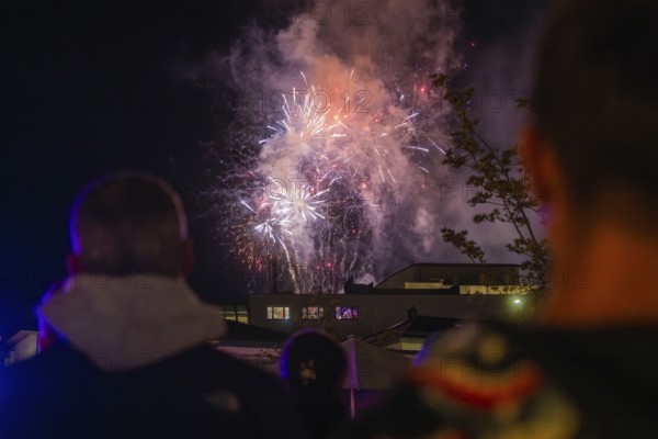 People watching fireworks in the night sky with smoke, Fire Night, Sindelfingen, Germany
