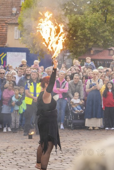 A fire show artist demonstrates her skills in front of a fascinated audience, Feuernacht, Sindelfingen, Germany