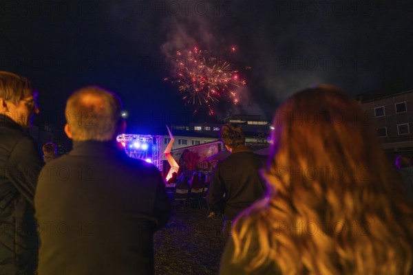 Spectators watching fireworks over an illuminated stage, nocturnal celebration, fire night, Sindelfingen, Germany