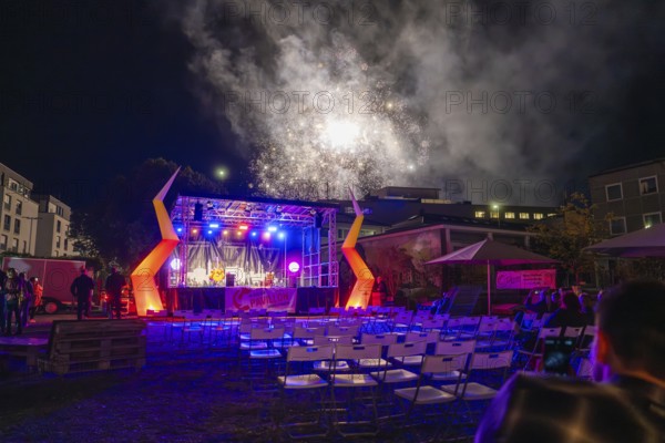 Open-air stage at night with fireworks and empty chairs, Feuernacht, Sindelfingen, Germany