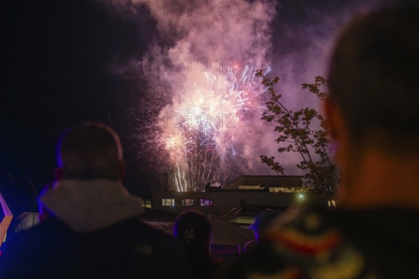 A spectacular firework display unfolds in the night sky while spectators watch, Fire Night, Sindelfingen, Germany