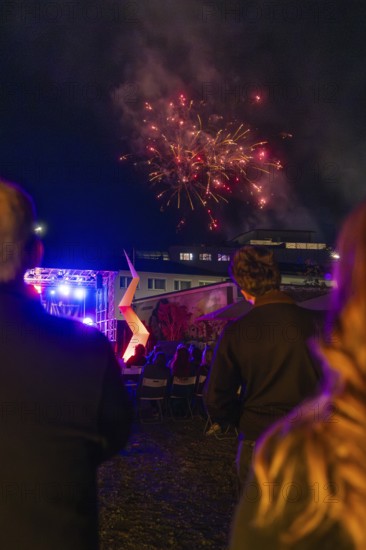 People enjoying fireworks over an illuminated outdoor event, Fire Night, Sindelfingen, Germany