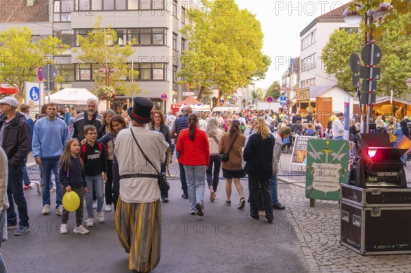 Crowds at a street festival, children with balloons and colourful stalls in an urban environment, Fire Night, Sindelfingen, Germany