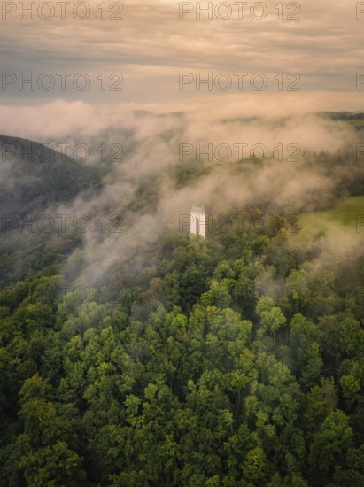 A tower rises out of a misty forest, shrouded by thick clouds, Schönbergturm, Pfullingen, Swabian Alb, Germany
