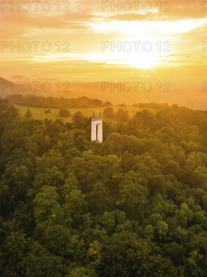 Tower in the middle of a forest under an orange-coloured sky at sunset, Schönberg Tower, Pfullingen, Swabian Alb, Germany