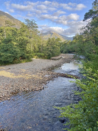 Mountain landscape with a clear flowing river and lush forests, Glen Nevis, Fort William, Scotland, Great Britain