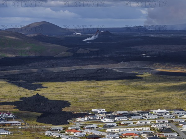 Lava, lava field, village, houses, summer, cloudy, sunny, aerial view, volcanic eruption, July 2025, Grindavik, Sundhnúkur crater series, Fagradalsfjall, Reykjanes, Iceland