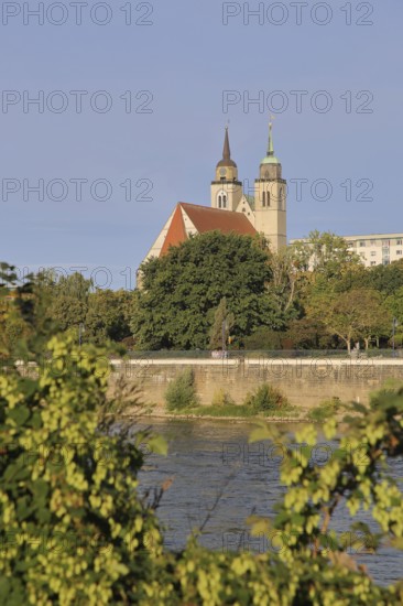 Late Romanesque St John's Church with twin towers and Elbe, Elbe riverbank, Magdeburg, Saxony-Anhalt, Germany