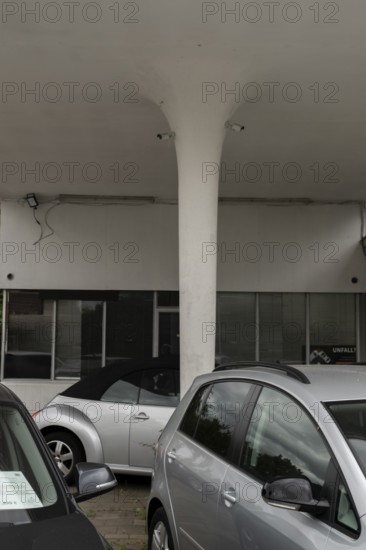View over cars for sale on a pillar of a roof of an old petrol station or car repair shop on which surveillance cameras are mounted, Wietzen, Nienburg, Lower Saxony, Germany