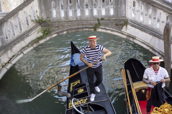 Venice, Italy - 3 September 2025: Gondolier on a gondola in Venice during the 82nd Venice International Film Festival