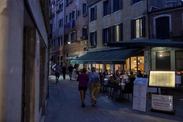 Venice, Italy - 2 September 2025: People stroll in San Marco in Venice at sunset during the 82nd Venice International Film Festival