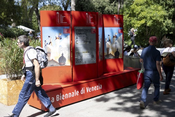 Venice, Italy - 3 September 2025: People walk past a billboard advertising the festival during the 82nd Venice International Film Festival