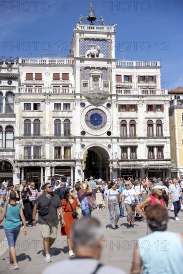 Venice, Italy - 3 September 2025: Tourists at the clock tower of San Marco on St Mark's Square in Venice during the 82nd Venice International Film Festival