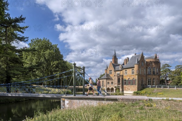 1824 iron suspension bridge in park of the Wissekerke Castle, Kasteel van Wissenkerke in the village Bazel near Kruibeke, East Flanders, Belgium