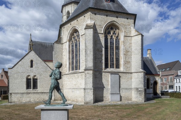 Statue Anzie Seppe, chiro boy in front of the Sint-Petruskerk, Saint Peter's Church in the village Bazel near Kruibeke, East Flanders, Belgium
