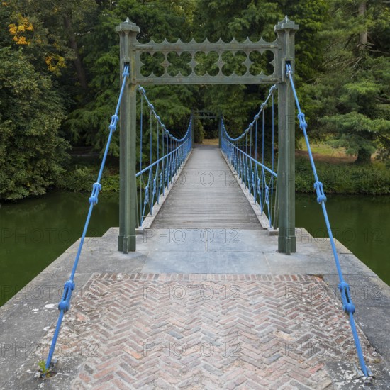 1824 iron suspension bridge in park of the Wissekerke Castle, Kasteel van Wissenkerke in the village Bazel near Kruibeke, East Flanders, Belgium