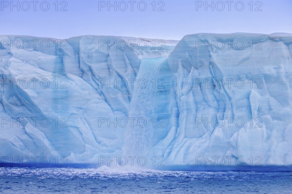 Waterfall at edge of the Brasvellbreen glacier from the ice cap Austfonna debouching into the Barents Sea, Nordaustlandet, Svalbard, Spitsbergen