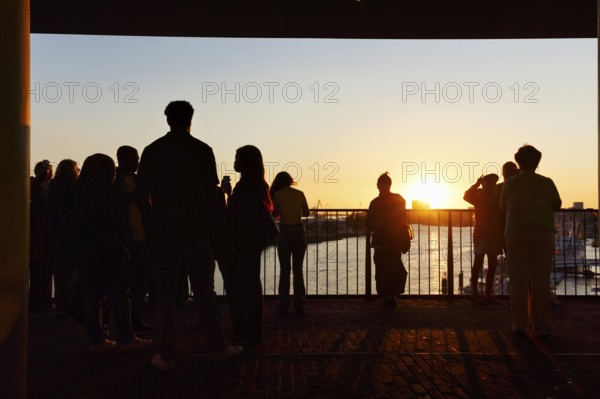 Crowd enjoying the view from the Elbphilharmonie over the Elbe at sunset, silhouettes, Plaza viewing platform, Hamburg, Germany