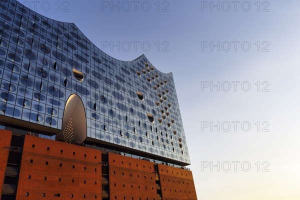 Facade of the Elbphilharmonie with Plaza viewing platform, blue sky, evening light, Hamburg, Germany