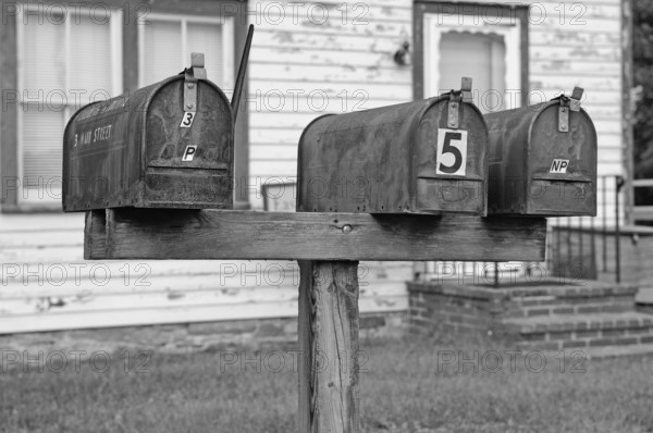 Rusty, private mailboxes in front of a house, Walpack, black and white, New Jersey, USA