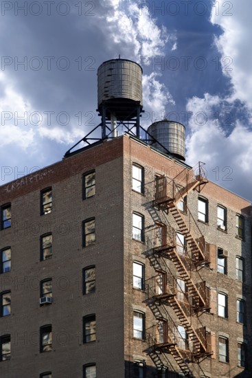 Residential tower with wooden water tanks on the roof, New York City, USA