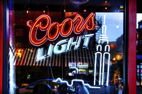 Illuminated advertising for Coors light, beer in a bar, New York City, USA