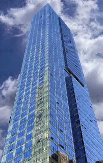 Glass facades of a skyscraper, cloudy sky, New York City, USA