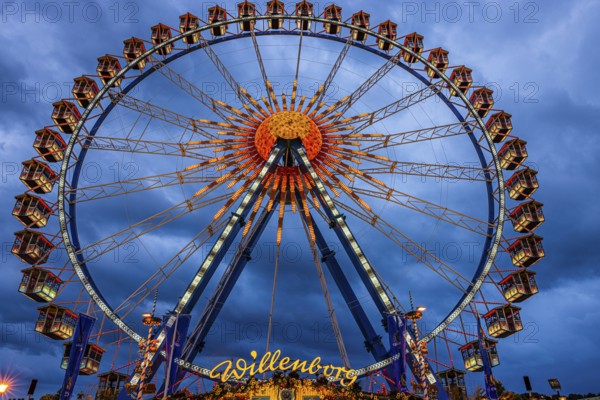 Dark clouds behind the illuminated Ferris wheel, Festwiese, Theresienwiese, Oktoberfest, Munich, Upper Bavaria, Bavaria, Germany
