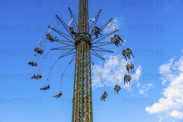 Oktoberfest attraction amusement ride Kettenflieger in front of a white-blue sky, Oktoberfest, Munich, Upper Bavaria, Bavaria, Germany