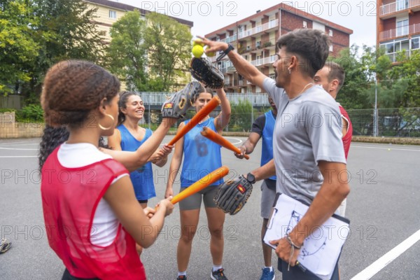 Diverse group of baseball players celebrates their victory, raising their bats, gloves, and balls in the air with joyful expressions, while their coach holds a clipboard with game strategies