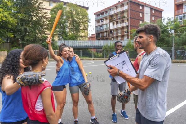 Female baseball players celebrating a victory with their coach holding a clipboard, discussing strategies and celebrating their success on the field