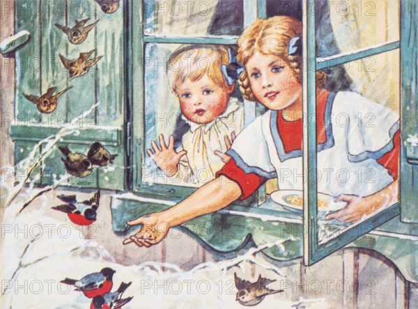 Old Christmas greeting card. Two girls at open window feeding small birds in the snow