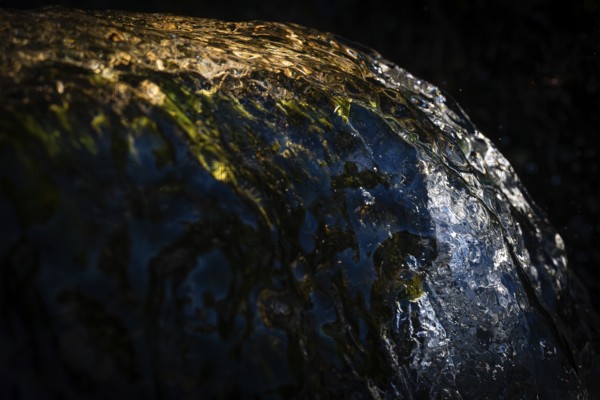 Water of a stream flowing over rocks, water jet, light reflections, Otroya or Otrøya Island, Møre og Romsdal, Norway