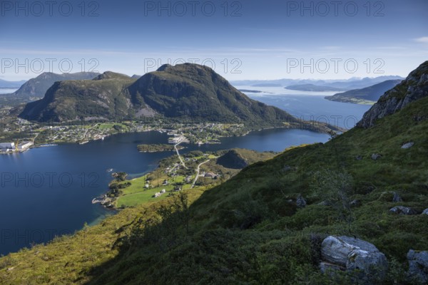 Expansive coastal view with mountains, sea and the village of Midsund, Otroya or Otrøya Island, Møre og Romsdal, Norway