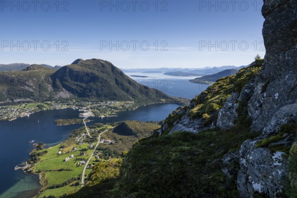 Expansive coastal landscape with mountains, sea and the village of Midsund, Otroya or Otrøya Island, Møre og Romsdal, Norway