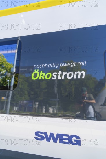 Train with sustainable ecological advertising and reflections on the window, battery Electric train with green electricity, Siemens Mireo Plus B, Freudenstadt, Germany