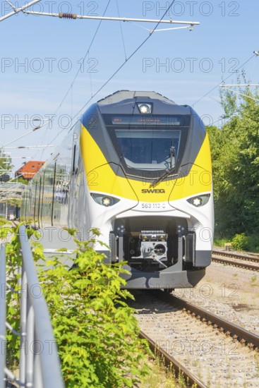 Train travelling on tracks under a clear sky, surrounded by green landscape, battery Electric train powered by green electricity, Siemens Mireo Plus B, Freudenstadt, Germany