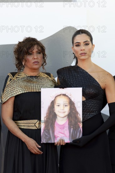 Venice, Italy - 3 September 2025: Kaouther Ben Hania and Saja Kilani with a portrait of five-year-old Palestinian girl Hind Rajab, who was killed by the Israeli army in the Gaza Strip in January 2024, during the red carpet of - The Voice Of Hind Rajab - during the 82nd Venice International Film Festival