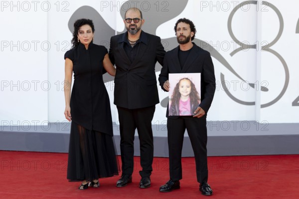 Venice, Italy - 3 September 2025: Clara Khoury, Amer Hlehel, Motaz Malhees with a portrait of five-year-old Palestinian girl Hind Rajab, who was killed by the Israeli army in the Gaza Strip in January 2024, during the red carpet of - The Voice Of Hind Rajab - during the 82nd Venice International Film Festival