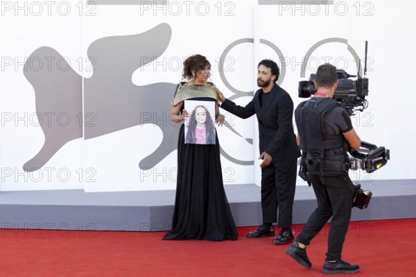 Venice, Italy - 3 September 2025: Kaouther Ben Hania with a portrait of five-year-old Palestinian girl Hind Rajab, who was killed by the Israeli army in the Gaza Strip in January 2024, during the red carpet of - The Voice Of Hind Rajab - during the 82nd Venice International Film Festival