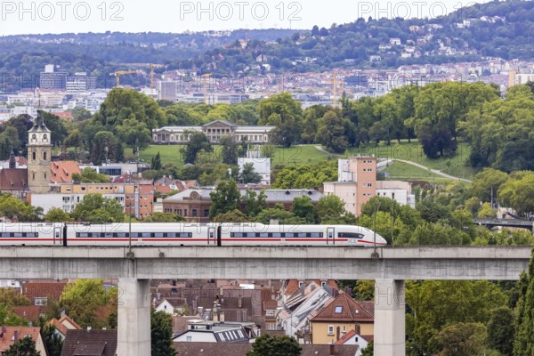 Deutsche Bahn AG ICE train travelling on the Schusterbahn, Münster viaduct with city view of Bad Cannstatt. Rosenstein Park, Rosenstein Castle. Stuttgart, Baden-Württemberg, Germany