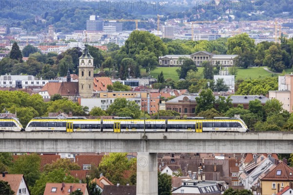 SWEG regional train travelling on the Schusterbahn, Münster viaduct with Bad Cannstatt and Rosensteinpark, Rosenstein Castle. Stuttgart, Baden-Württemberg, Germany